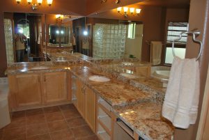 A large bathroom with granite counter tops and tile floors.