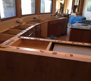 A kitchen with wooden cabinets and counters being built.