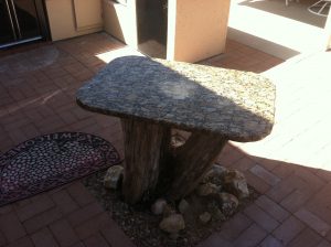 A stone table in the middle of a courtyard.