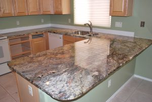 A kitchen with granite counter tops and wooden cabinets