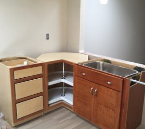 A kitchen with wooden cabinets and drawers in it